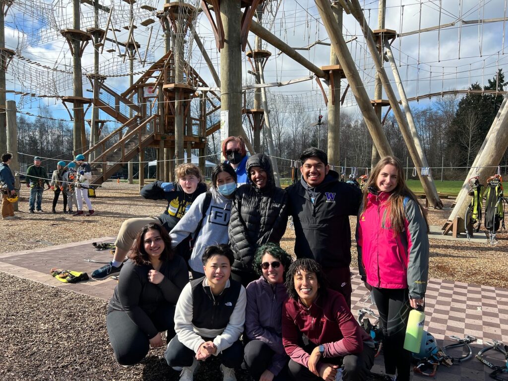Ŷĳs smiling in front of high ropes course at High Trek Adventures