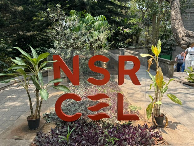 A sign outdoors with the NSRCEL logo