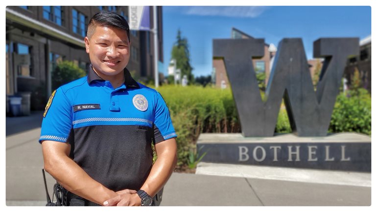 Officer Rodel Cruz Naval on campus in front of the W statue